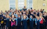 Goalkeeper Brendan Carmody holds the cup high as pupils at Adare&rsquo;s Shountrade NS cheer on their team