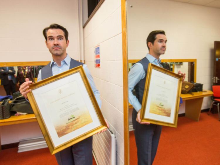 Limerick roots: comedian Jimmy Carr receives a 'certificate of Irish heritage' before his show in the UCH on Saturday night. Picture: Sean Curtin