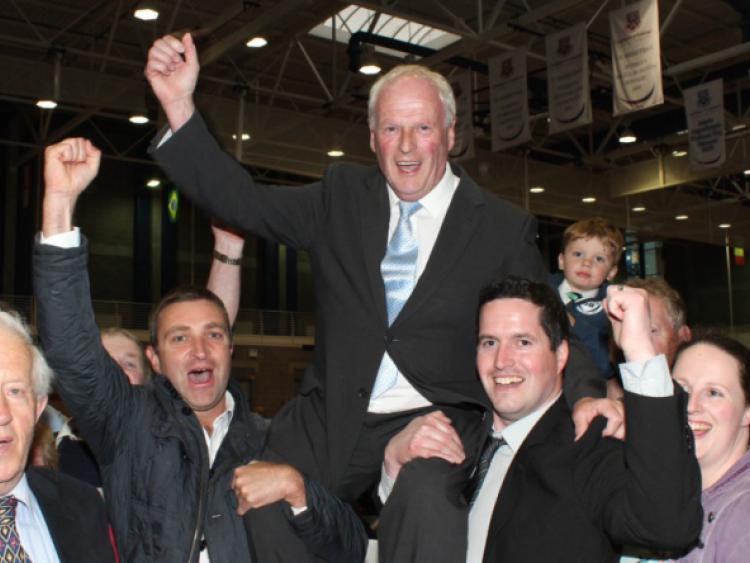 On the up: Cllr Eddie Ryan gets a lift from Niall Collins TD, and his son Malacky Ryan, at the local election count last May