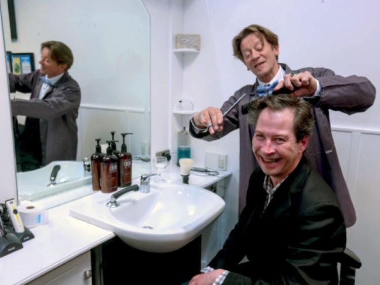 Myles Breen gets a trim from leading actor Brendan Conroy at the launch of the The Bachelor of Kilkish, which opens this Wednesday. Picture: Keith Wiseman