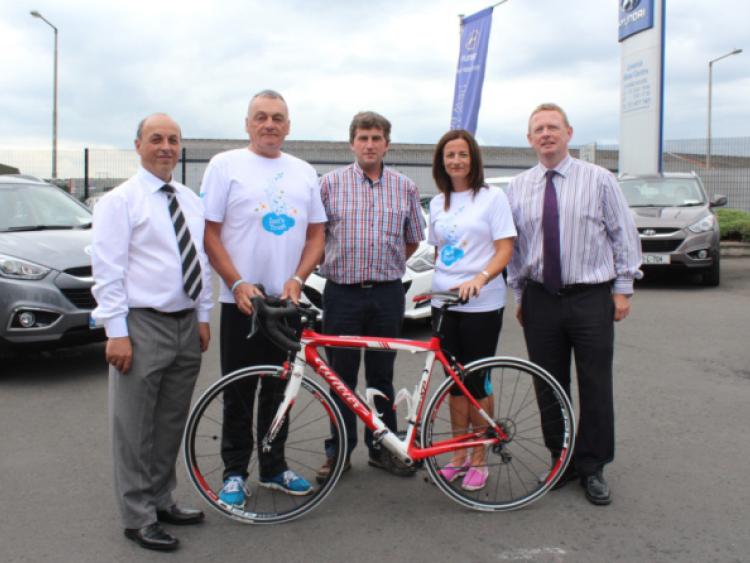 Founders of Ian's Trust, Oorla and John Cusack, with staff of Limerick Motor Centre at the launch of the To The Moon And Back cycle and run/walk, which will take place in Kilkee on August 16