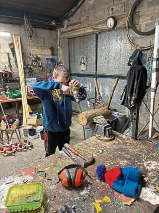Drill, baby drill! Mark Ryan, 13, hard at work in his carpentry shed making the unique reindeer he sells at Christmas with his friend Jack Byrnes