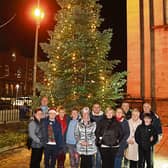 Canon Derek Leonard, with parishioners at St Joseph’s Christmas tree | PICTURE: Adrian Butler