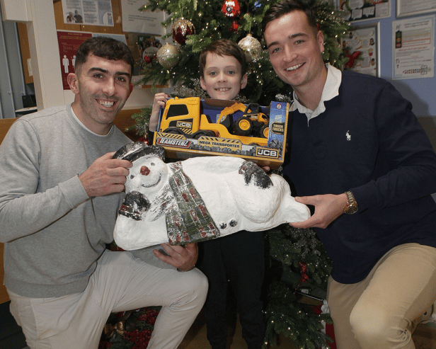 Four ice cool customers: Hurling stars Aaron Gillane and Kyle Hayes gift a truck and digger to Nathan Gleeson, Raheen, during a visit to the Children's Ark in UHL I PICTURE: Dave Gaynor