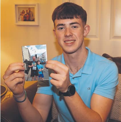 Running has always been in 17-year-old Chris O’Connor’s blood. He’s photographed here clutching a picture of him and his late father James, who tragically died on his 40th birthday | Adrian Butler