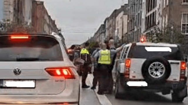 A still from a video widely shared on social media of gardai beside the hummer