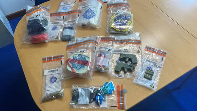 Two people are being questioned by gardai following the seizure of a large quantity of contraband, including 3D printed firearms, during searches of a number of homes in Clare and Tipperary