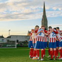 Treaty United players in a huddle with the spire of St John's Cathedral in the background | PICTURE: Kieran Ryan-Benson