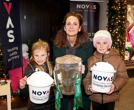 Pictured at laast year's Novas Sleep Out outside Brown Thomas, Dr Una Burns, policy director, Novas with Rosa and Kitty Burns, holding the Liam MacCarthy cup | PICTURE: Adrian Butler