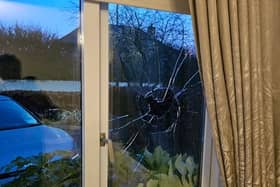 The  damaged window at the family home