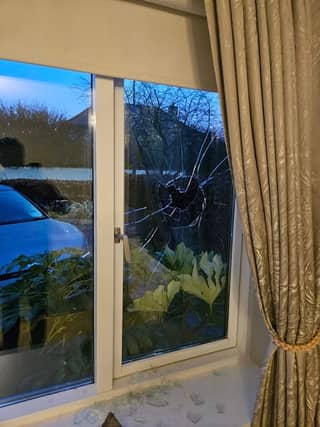 The damaged window at the family home