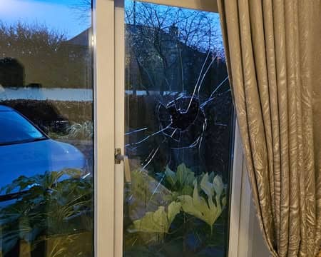 The  damaged window at the family home