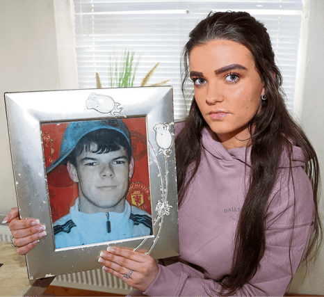 Nikita Hannan with a picture of her late father, Jeffrey Hannan, who was murdered in 2007. No person has been prosecuted to date for the murder