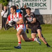 Oola's Cian O'Donovan breaks out of defence as Todd Donovan, of Newcastle West, closes him down during Thursday's Limerick SFC clash in Rhebogue | PICTURE: Kieran Ryan-Benson