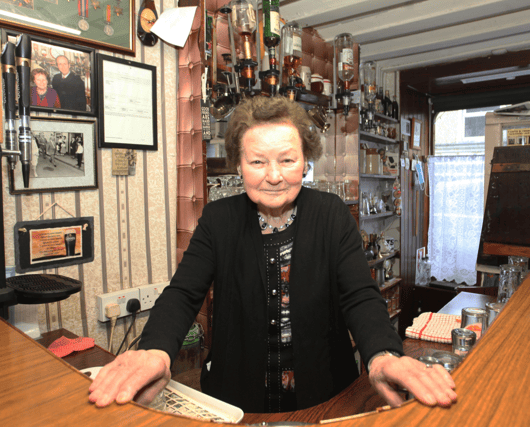 The late Peg Carmody behind the bar in Hospital in 2022 I PICTURE: Brendan Gleeson