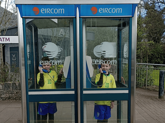 Twins Ben and Lee Lyons, Patrickswell, pose in the county's last payphones