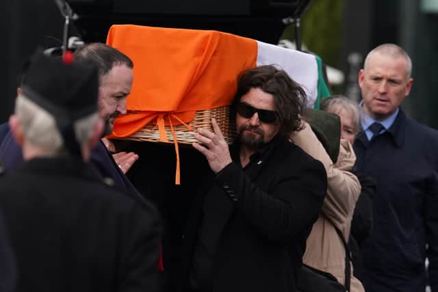 Earlier the coffin had been draped in the Irish national flag as it was carried towards the Crematorium Chapel of Glasnevin Cemetery in Dublin, led by a lone piper.