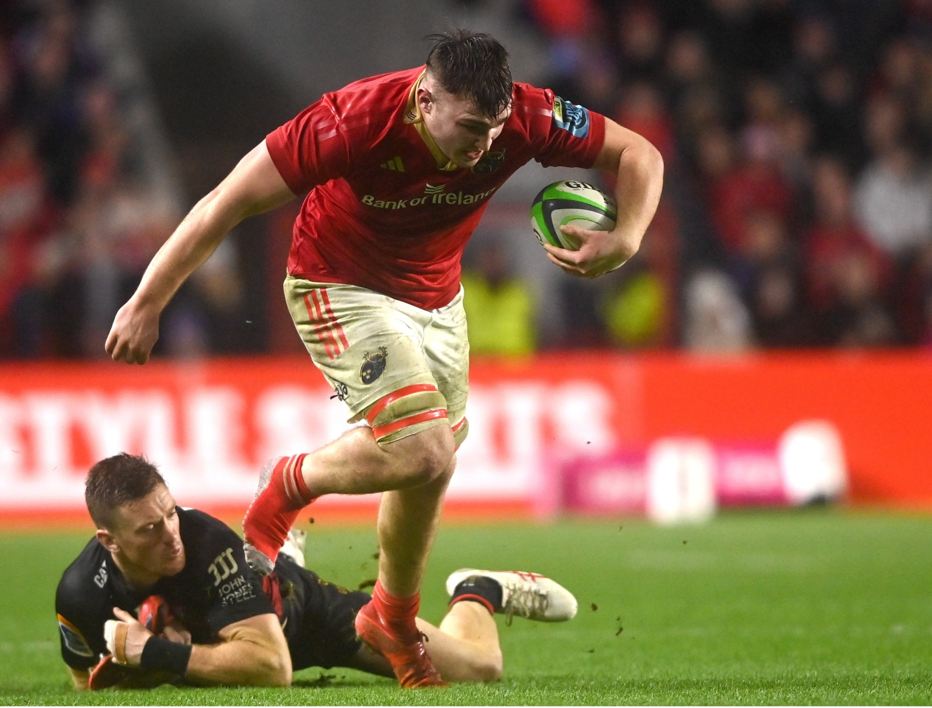 Fineen Wycherley, of Munster, breaks away from Dallas McLeod, of Crusaders, during the international rugby fixture played at Pairc Ui Chaoimh on Saturday evening PICTURE: Sportsfile