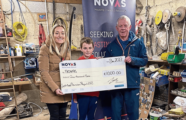 Jackie Leonard, head of fundraising at Novas, with Mark Ryan, 11, Jack Byrnes and some of the reindeer the pair made before Christmas