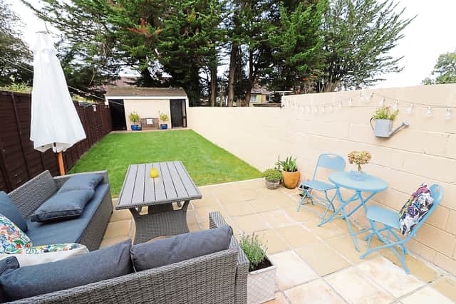 Outside, there is a private manicured rear garden with a patio area, garage and side entrance.