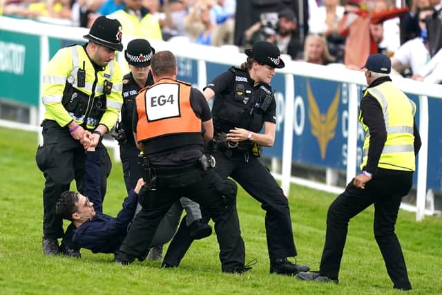 Shortly after, a woman tried to jump the fence in front of the grandstand as police officers rushed to stop her.