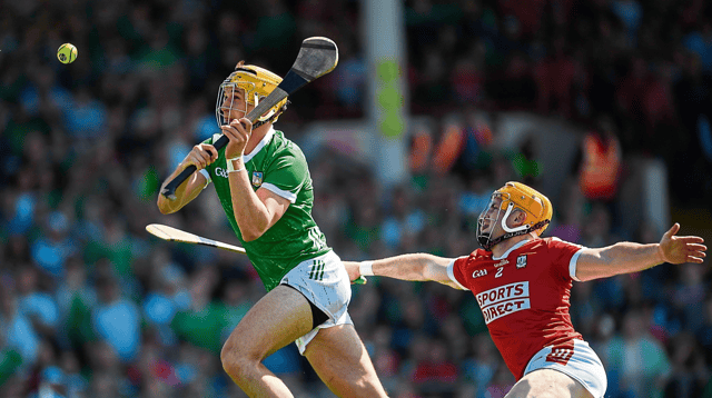 Limerick's Cathal O'Neill scores his side's second goal despite the challenge from Niall O'Leary, of Cork, during Sunday's Munster SHC fixture at the TUS Gaelic Grounds