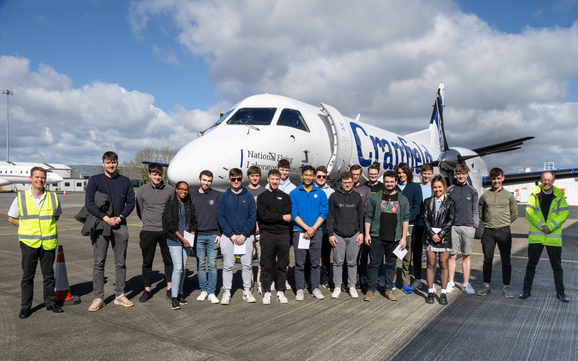 UL aeronautical engineering students on a Shannon Airport runway with Robert Harrison, Captain of the National Flying Laboratory Centre, and Dr Simon Place, from Cranfield University