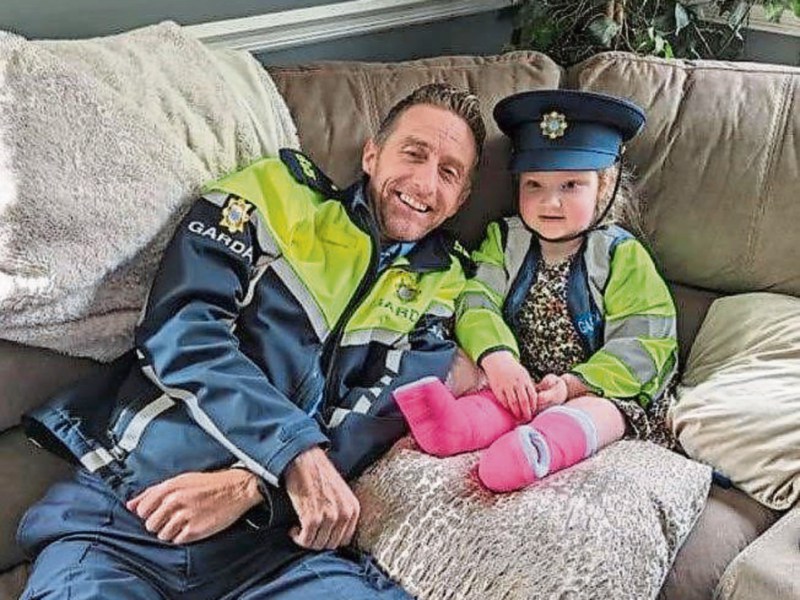 Mia Farrell, age five, with her best friend Garda Ollie O'Sullivan who visited her home during Easter |  PICTURE: An Garda Siochana/Twitter