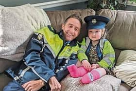 Mia Farrell, age five, with her best friend Garda Ollie O'Sullivan who visited her home during Easter |  PICTURE: An Garda Siochana/Twitter