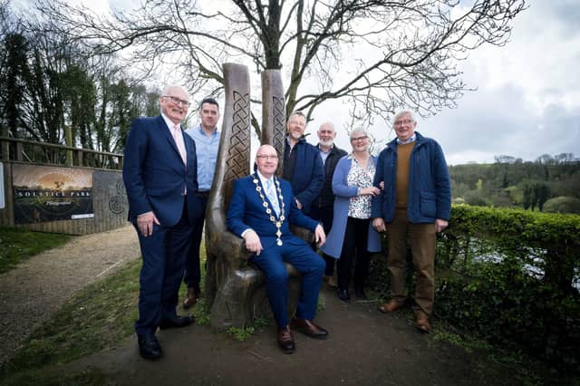 Mayor Francis Foley in historical chair at Lough Gur site for launch of ownership transfer, with community surrounding