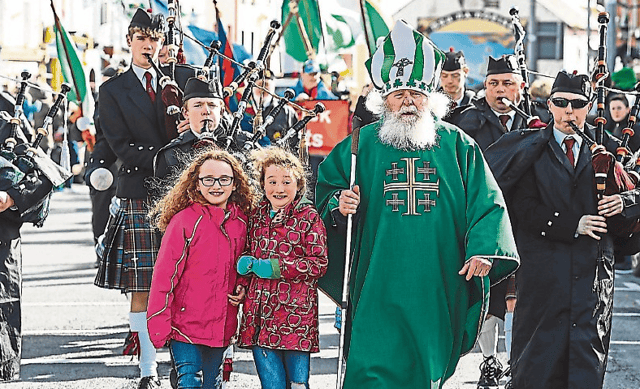 St Patrick, Mike Toomey, with his granddaughters Laura and Rena pictured at the St Patrick's Day parade in Bruff in 2019. The Bruff parade will return this year