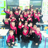 Students of Scoil Naomh Iósaf cheer on the Adare team  ahead of the county final
