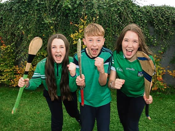 Pupils from Scoil Mocheallog cheering on Kilmallock ahead of the county hurling final against Na Piarsaigh | PICTURES: Adrian Butler