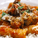 The word rigatoni comes from the Italian word rigato  which means ridged or lined, and is associated with the cuisine of southern and central Italy