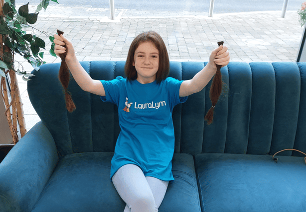 Emma Ray, Rhebogue, shows off her new bob in Niall Colgan’s, and 12 inches of her old hair which will be donated