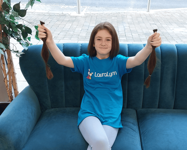 Emma Ray, Rhebogue, shows off her new bob in Niall Colgan’s, and 12 inches of her old hair which will be donated