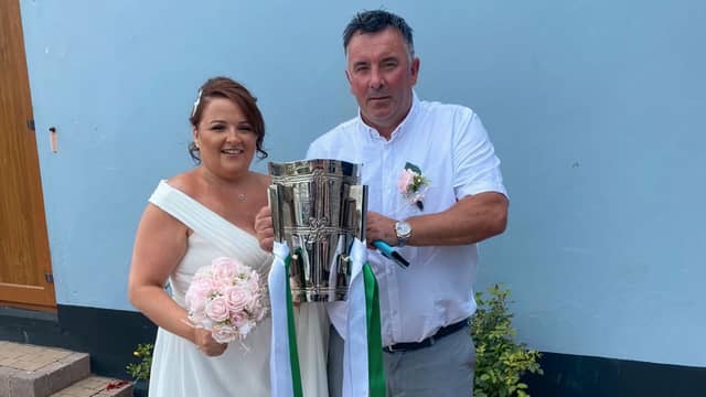 Three's company! Newlyweds Linda and Tom Donegan pictured with the Liam MacCarthy Cup at their wedding celebration
