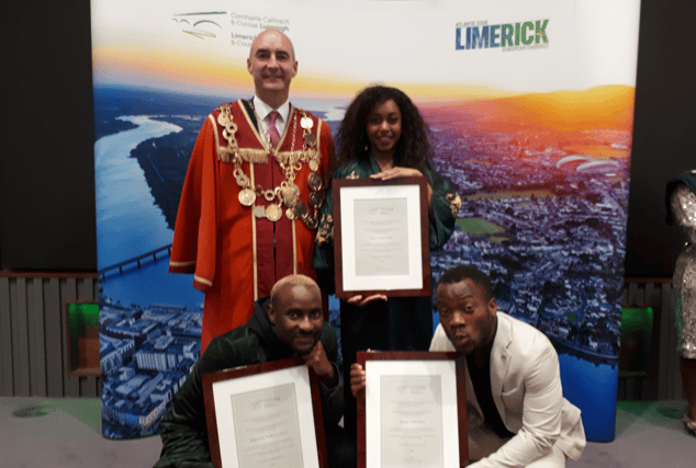 Mayor Daniel Butler with Mawuli MuRli Boevi, Denise Mwaka Chaila and Munyaradzi Godknows Jonas after they were presented with scrolls marking the reception