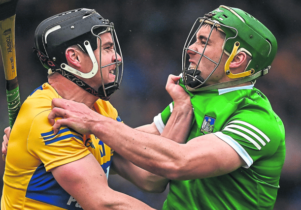 Hurling Titans: Seán Finn, of Limerick, right, and Tony Kelly, of Clare, get up close and personal during Sunday's Munster senior hurling final at FBD Semple Stadium