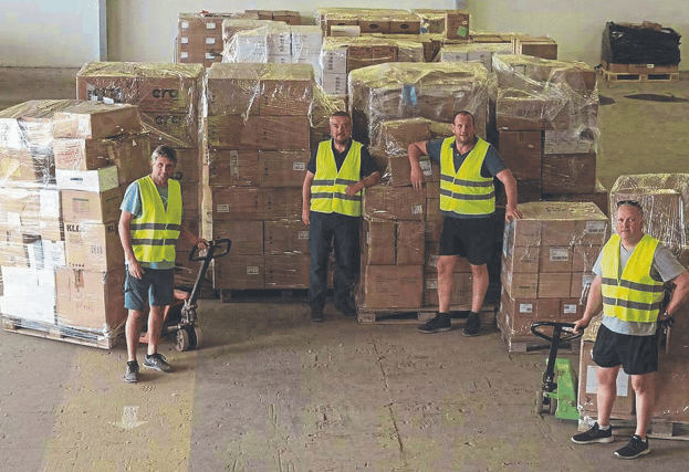 Norman Sheehan, Ray Jordan, Shane Leahy and Ken Costelloe with a with a consignment of medical aid and (below) taking shelter in Ukraine