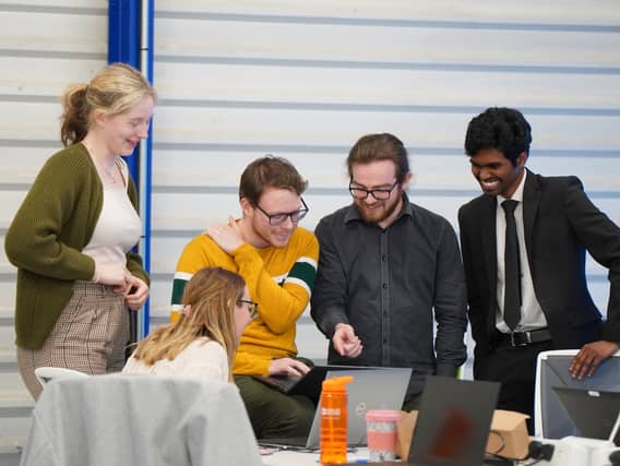 Emma O'Donovan, Enda Kilgarrif, Adam Fahy and Souvik Kundu brainstorming their winning concept at the Analog Devices International hackathon