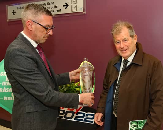 Thomas Ryan of Greyhound Racing Ireland with sponsor JP McManus and the Con and Annie Kirby Memorial winning trophy