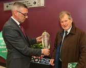 Thomas Ryan of Greyhound Racing Ireland with sponsor JP McManus and the Con and Annie Kirby Memorial winning trophy