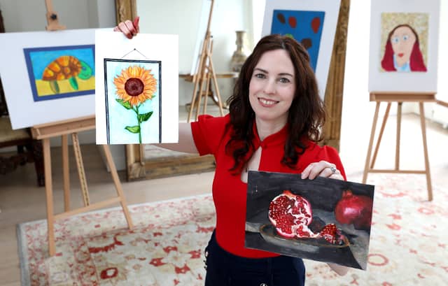 Pictured is adjudicator, Marie Connole, holding two of the entries received from students in County Limerick