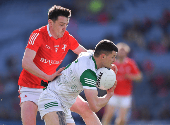 Iain Corbett of Limerick in action against Tommy Durnin of Louth during the Allianz Football League Division 3 final at Croke Park on Saturday