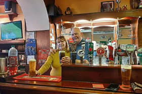 Last orders, please: Jim and Kathleen Lynch pull a pint on the final night in their Kilmallock pub. It was the last bar on the town’s central street