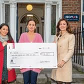 Charlotte Azzopardi and Petra Hayes of Cook Medical presenting Una Burns of Novas, Limerick with a cheque for more than €23,000 | PICTURE: Alan Place