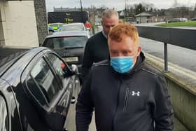 Declan Haughney (front, wearing mask) arrives at Kilkenny Courthouse this morning