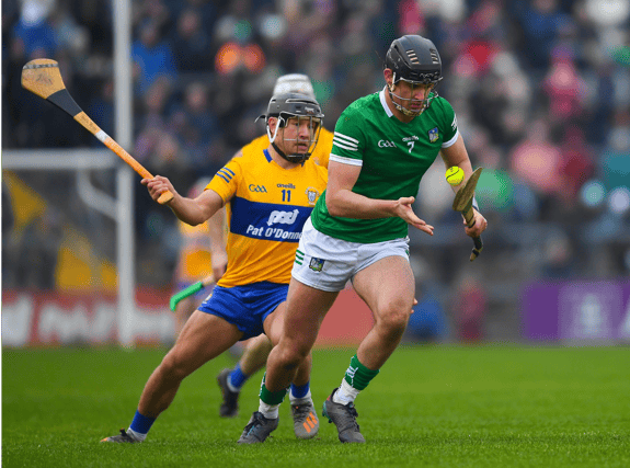Limerick's Paddy O'Loughlin is tackled by David Reidy of Clare during the 2022 Co-op Superstores Munster Hurling Cup final at Cusack Park, Ennis on Sunday
