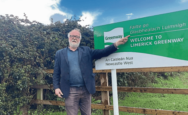 Cllr Jerome Scanlan pictured at one of the signs at the Greenway he feels shows a ‘bastardised’ use of language